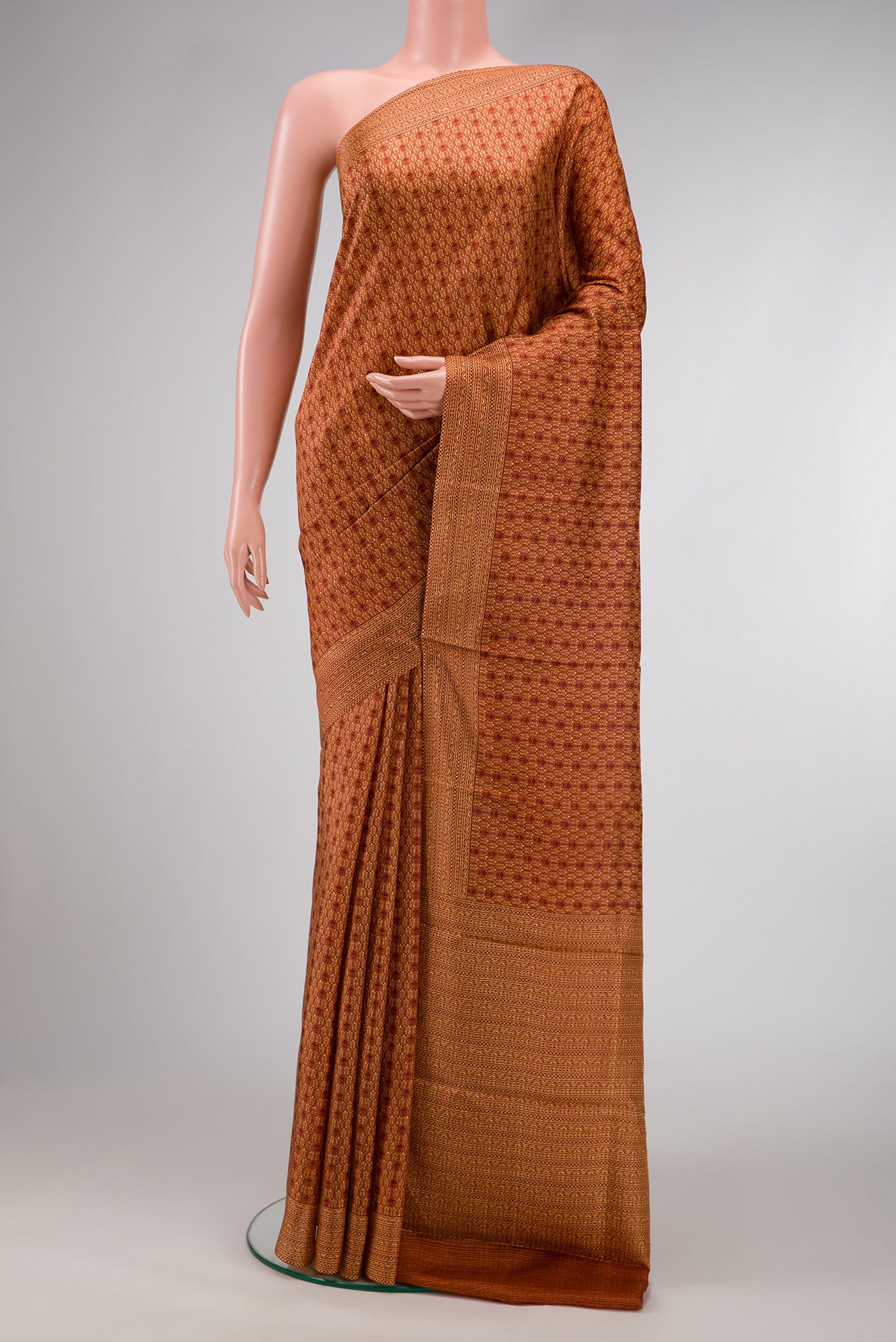 Rust Dual Tone Printed Silk Saree with Printed design on the body and Printed Border.  displayed on a mannequin