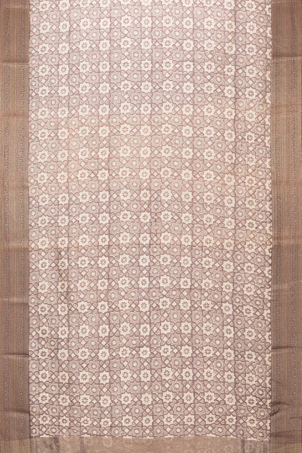 Flat view of Brown Dual Tone Chanderi Silk Saree with Printed design on the body and Zari Border. 