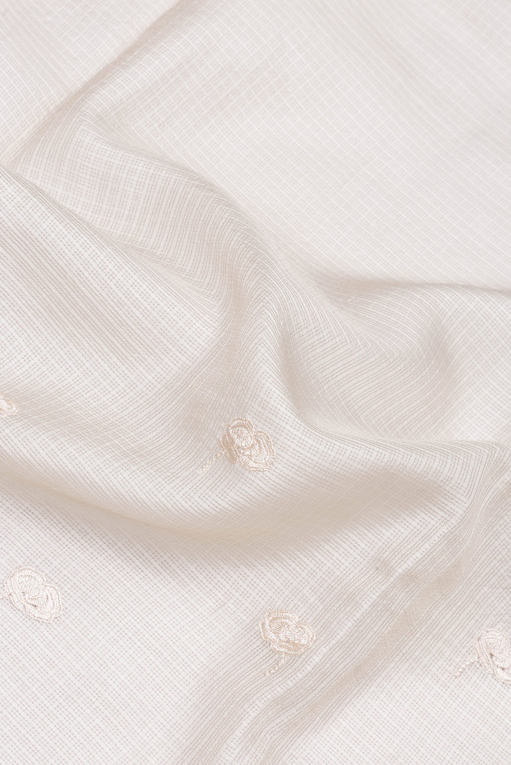 Close up of Beige Kota Silk Saree with Embroidery on the body and Embroidery Border.  displaying folds