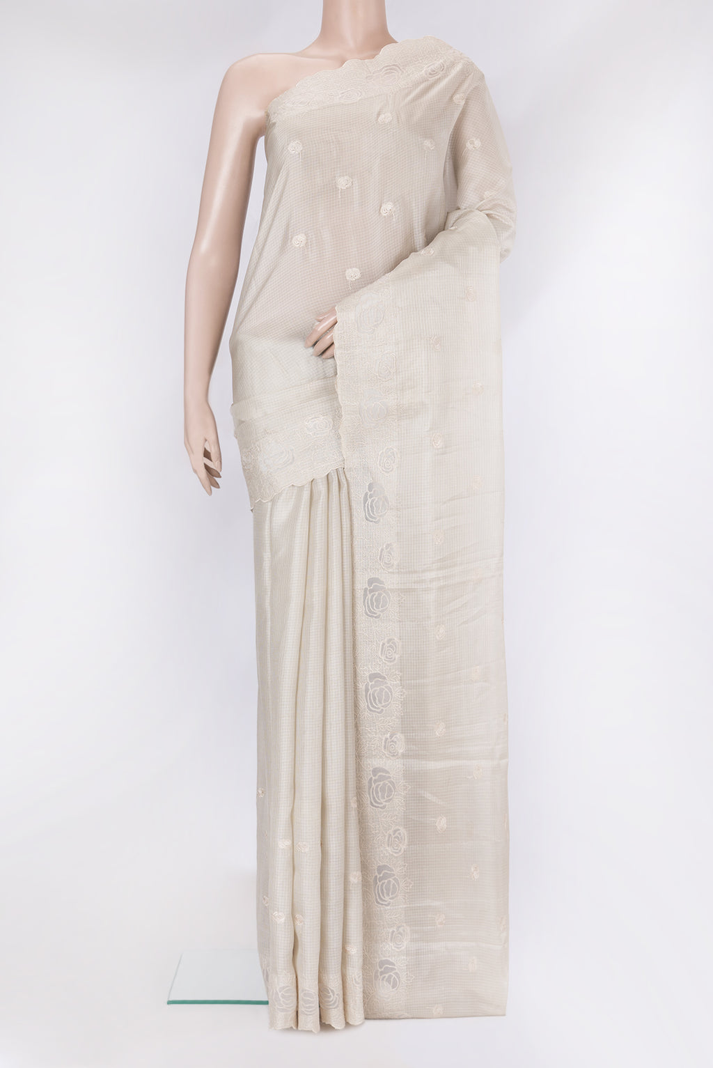 Beige Kota Silk Saree with Embroidery on the body and Embroidery Border.  displayed on a mannequin