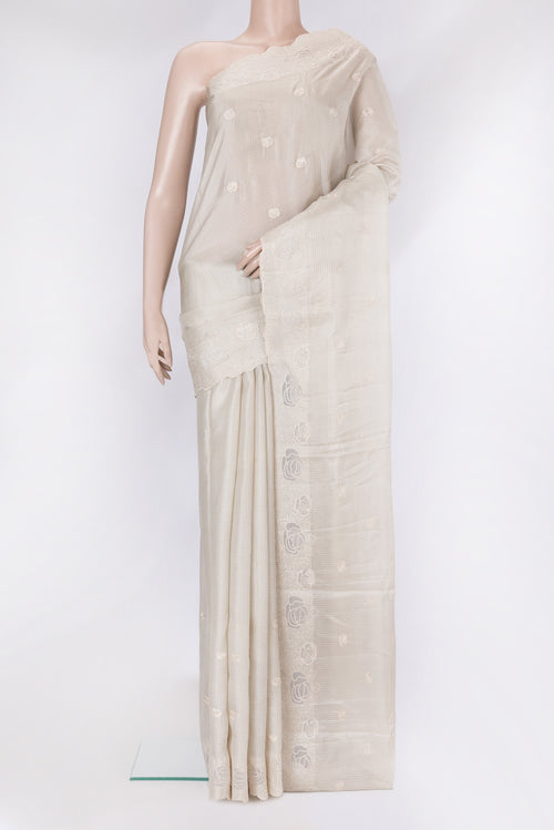 Beige Kota Silk Saree with Embroidery on the body and Embroidery Border.  displayed on a mannequin