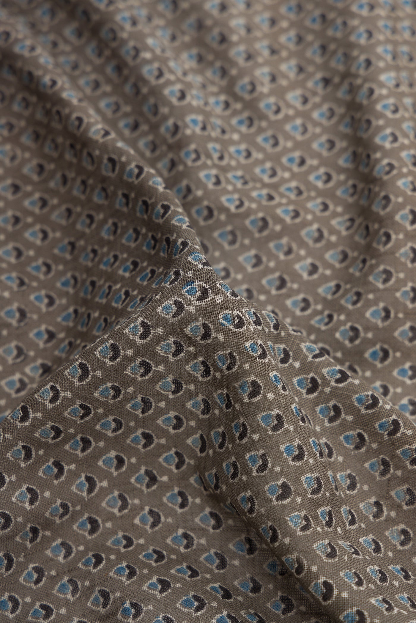 Close up of Grey Dual Tone Cotton Saree with Ajrakh Print on the body and Zari Border.  displaying folds