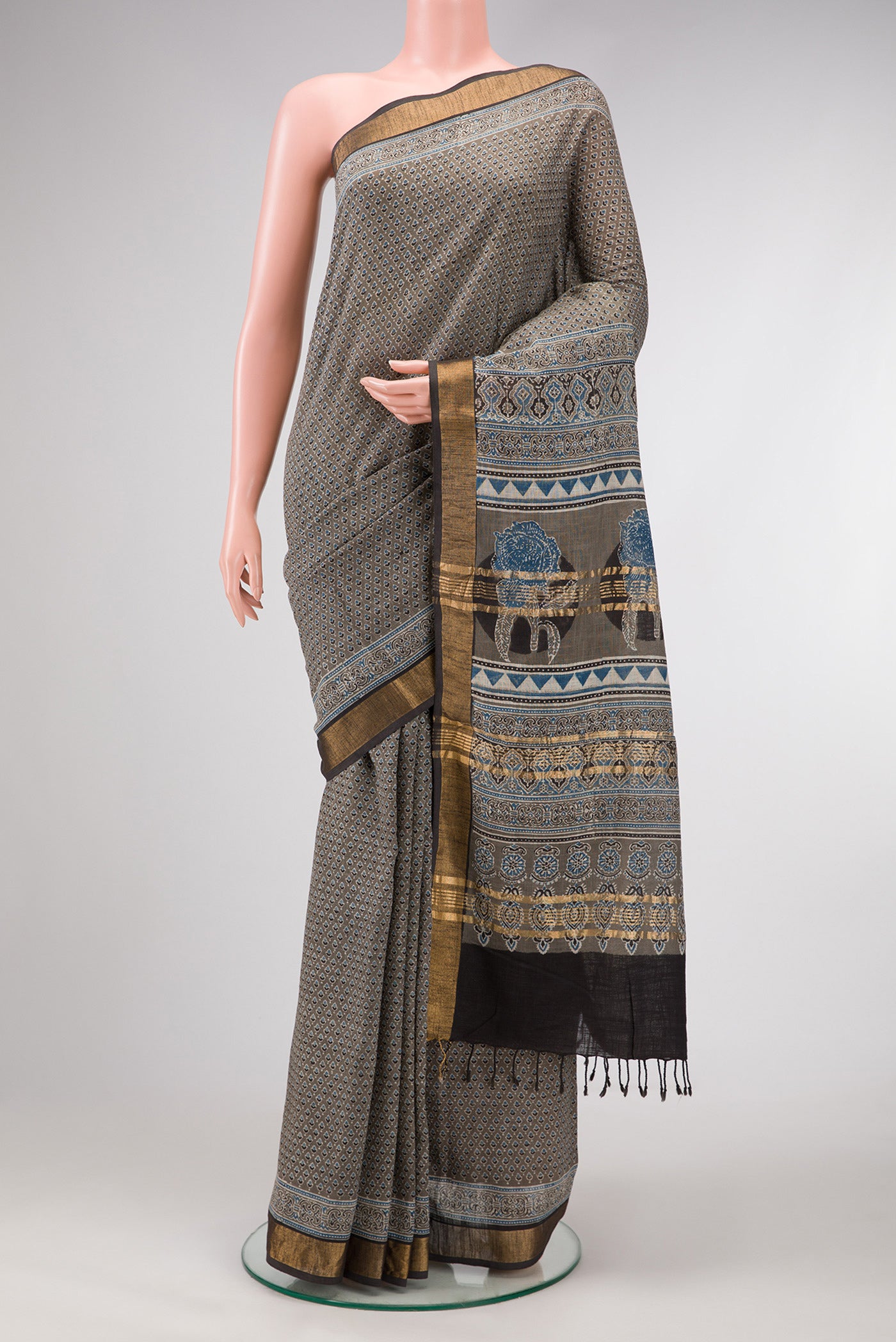Grey Dual Tone Cotton Saree with Ajrakh Print on the body and Zari Border.  displayed on a mannequin