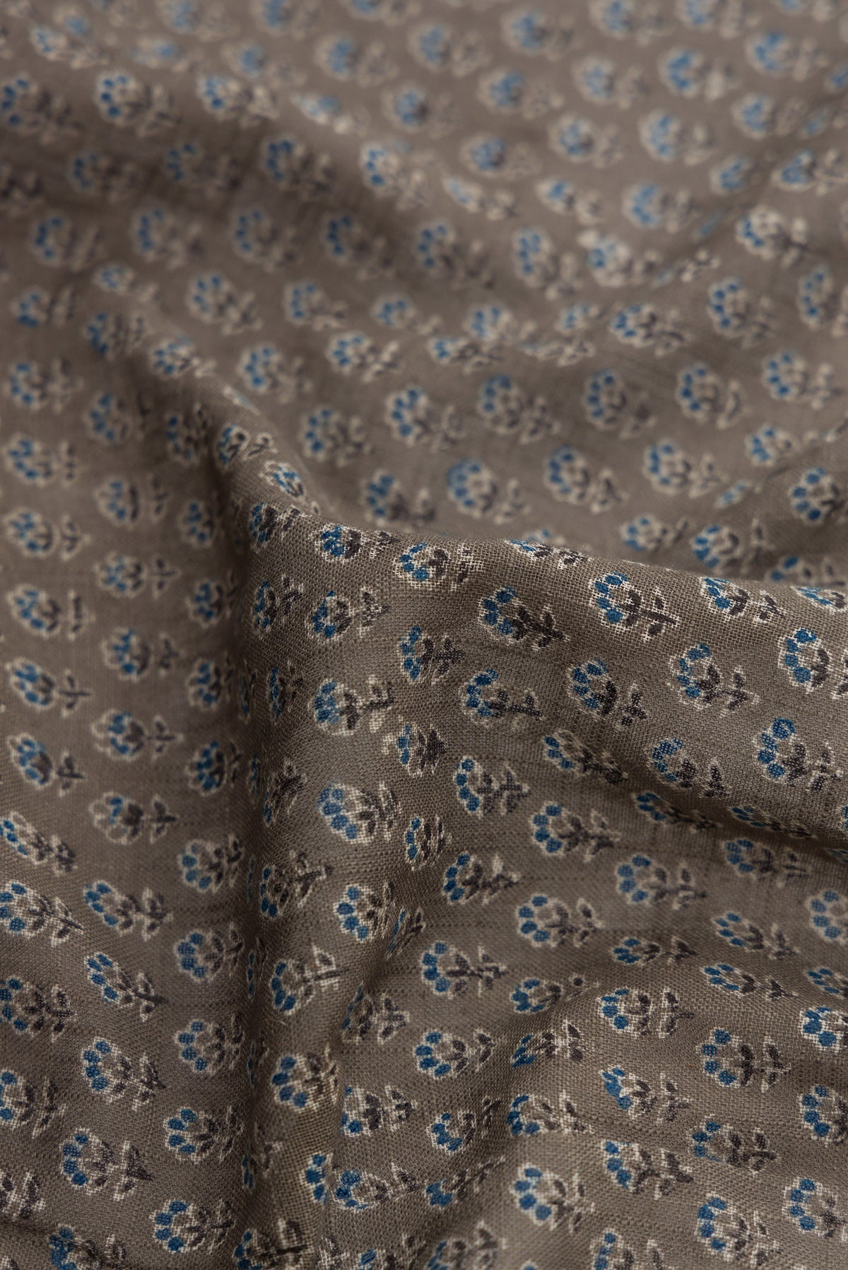 Close up of Grey Dual Tone Cotton Saree with Ajrakh Print on the body and Zari Border.  displaying folds