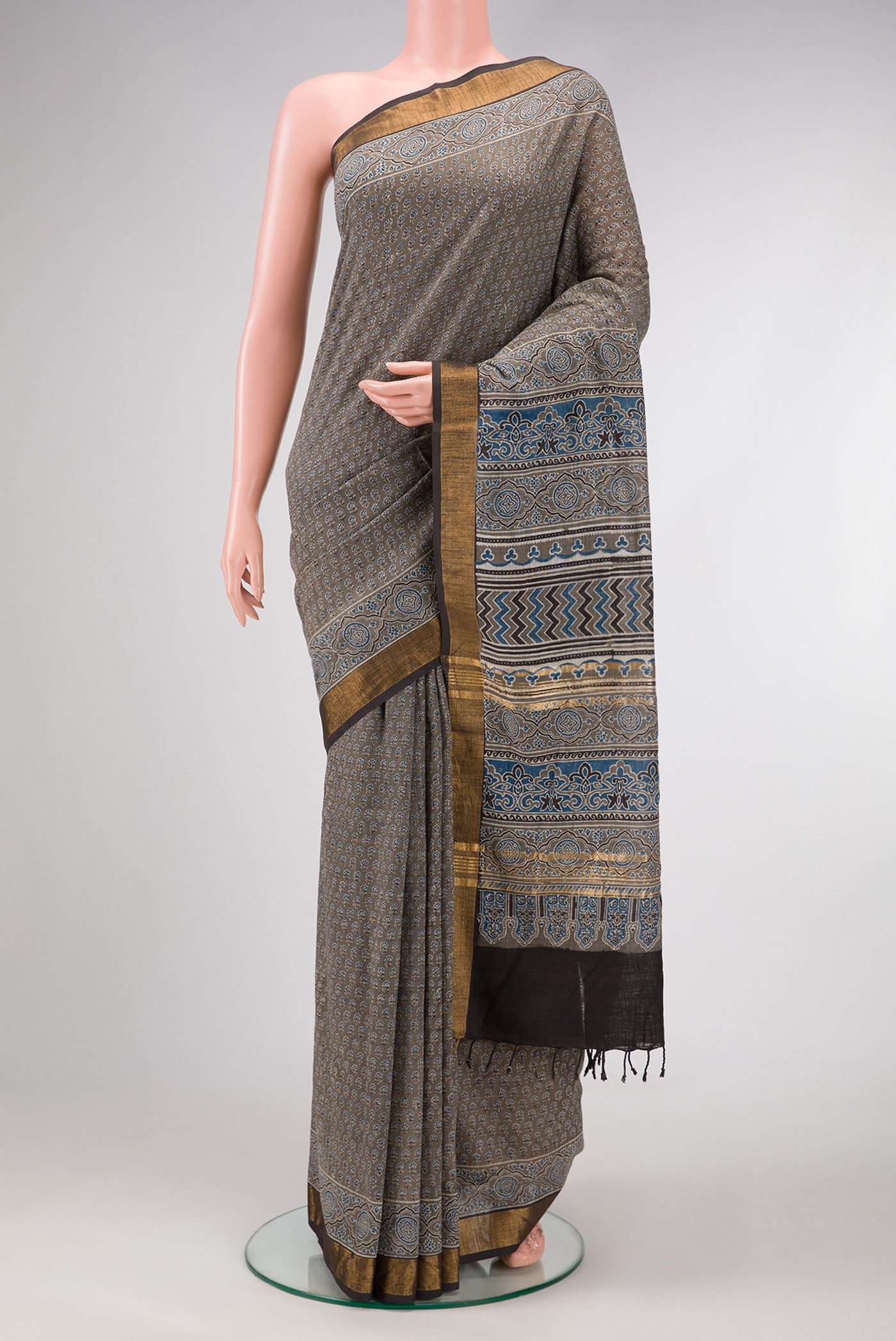 Grey Dual Tone Cotton Saree with Ajrakh Print on the body and Zari Border.  displayed on a mannequin