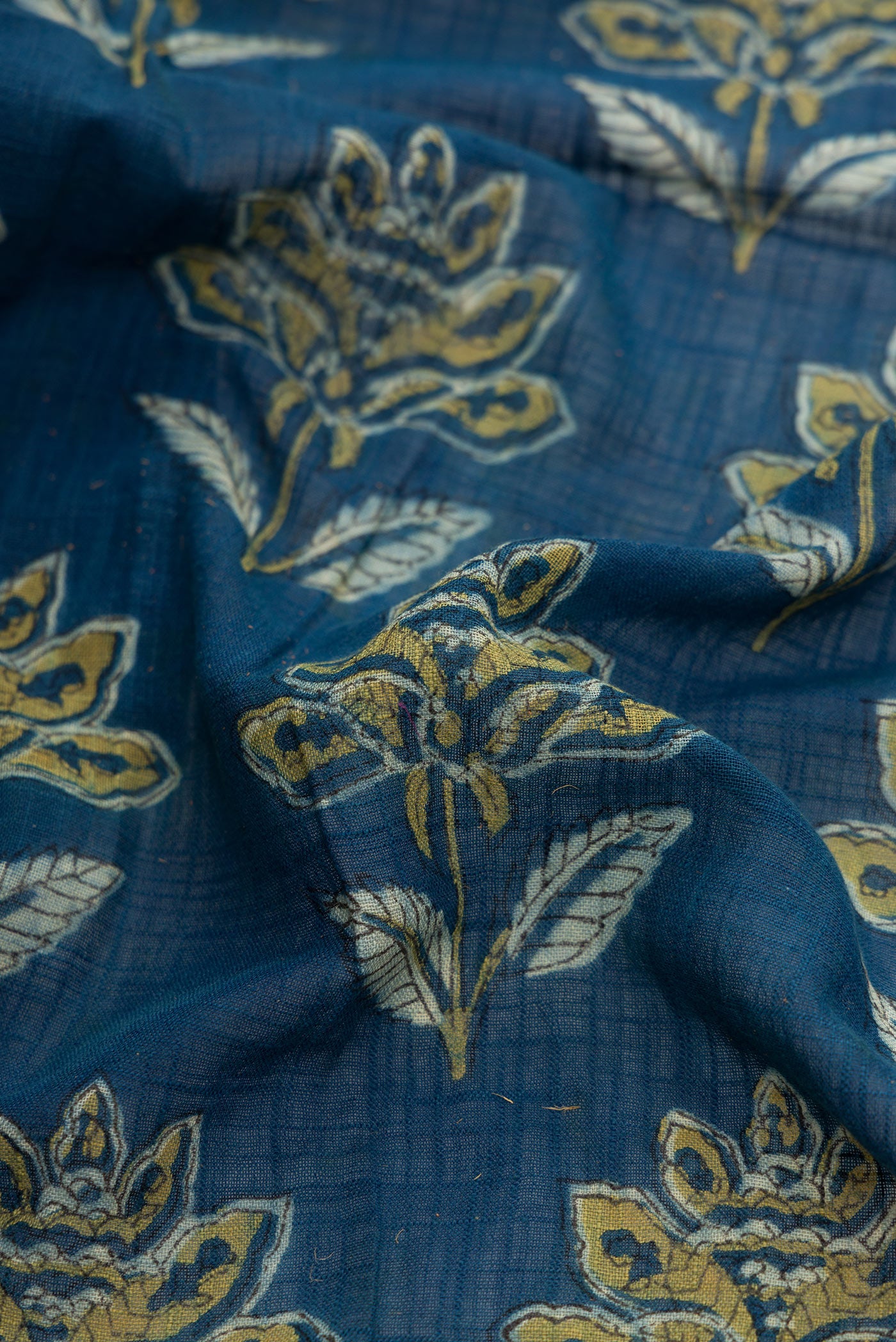 Close up of Navy Blue Dual Tone Cotton Saree with Ajrakh Print on the body and Zari Border.  displaying folds