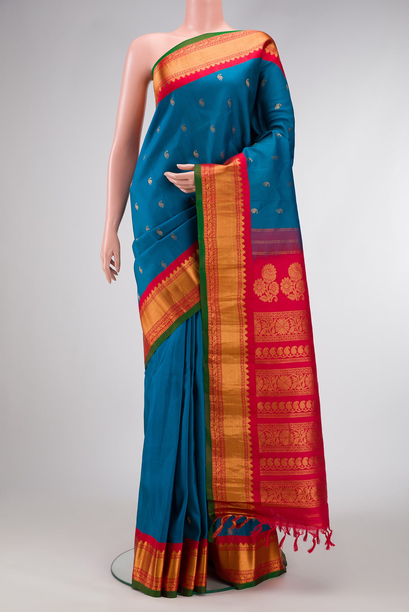 Peacock Blue Dual Tone Gadwal Silk Saree with Zari Butta on the body and Zari Border.  displayed on a mannequin