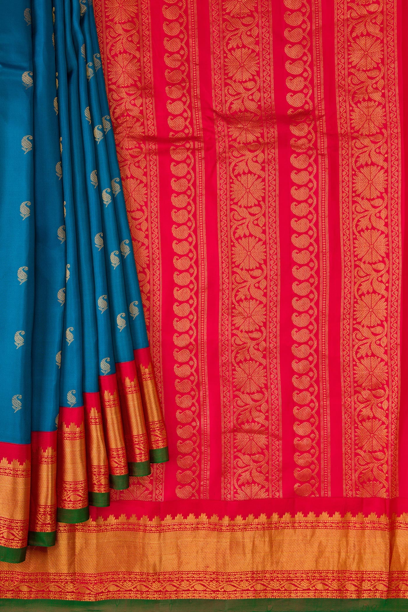 Pleats and pallu of Peacock Blue Dual Tone Gadwal Silk Saree with Zari Butta on the body and Zari Border. 