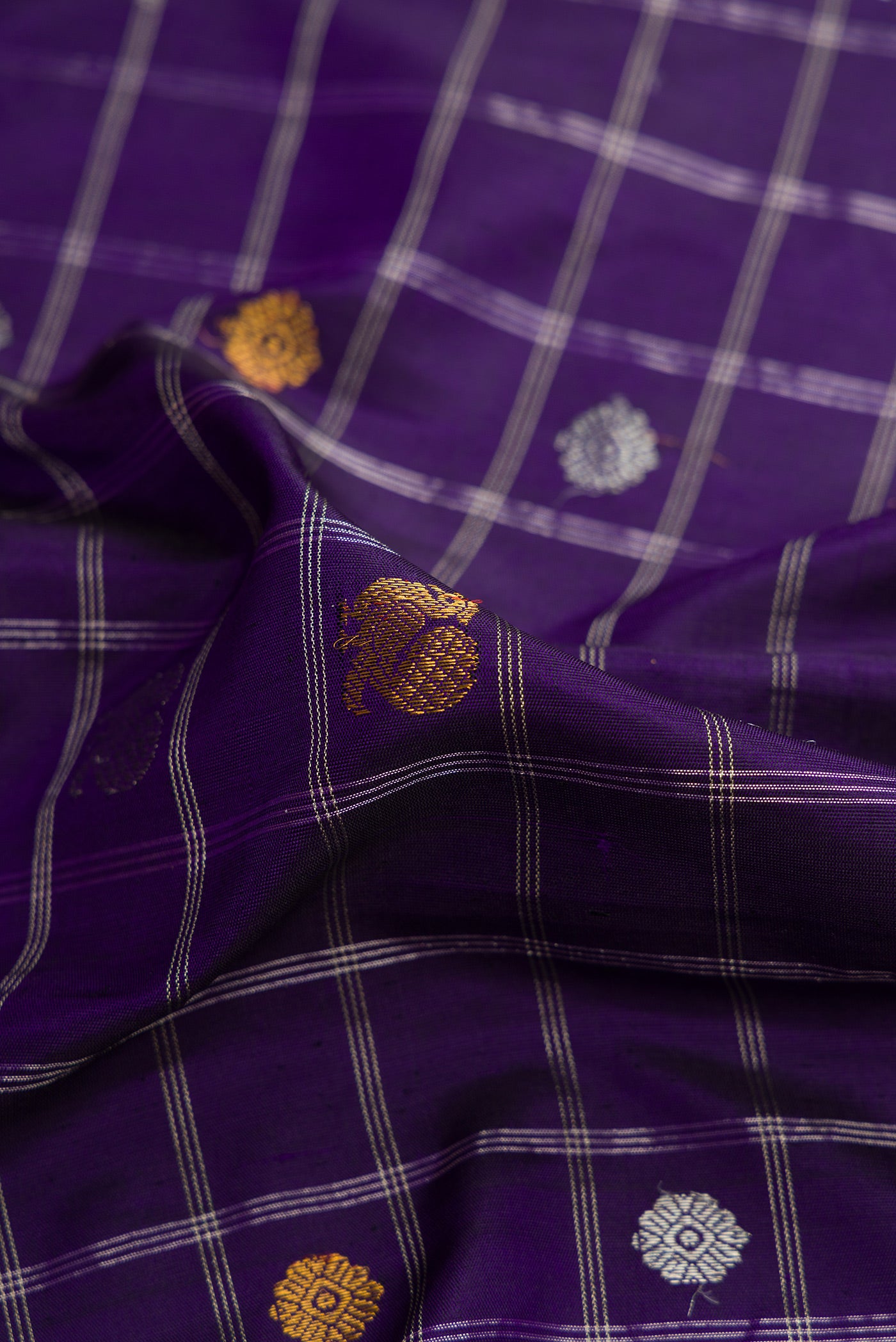 Close up of Royal Blue Dual Tone Gadwal Silk Saree with Checked design on the body and Zari Border.  displaying folds
