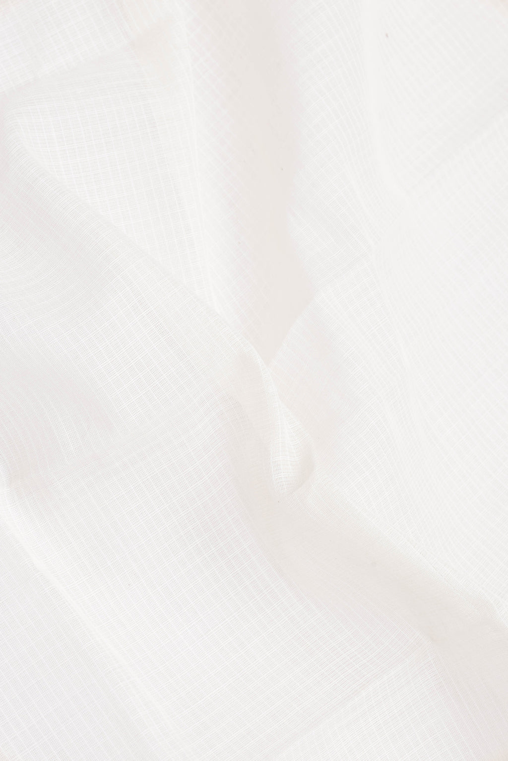 Close up of White Gadwal cotton Saree with Checked design on the body and Zari Border.  displaying folds