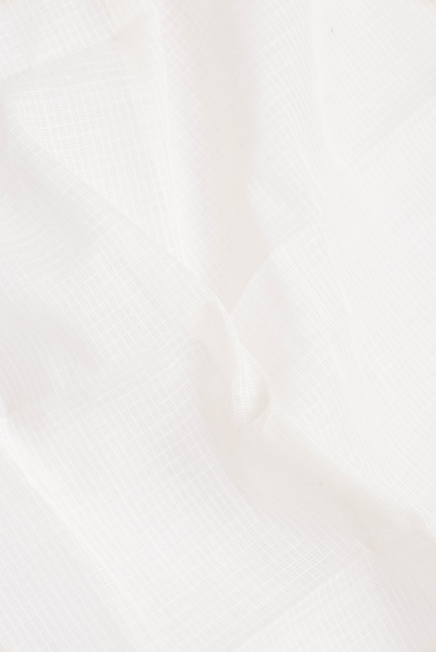 Close up of White Gadwal cotton Saree with Checked design on the body and Zari Border.  displaying folds