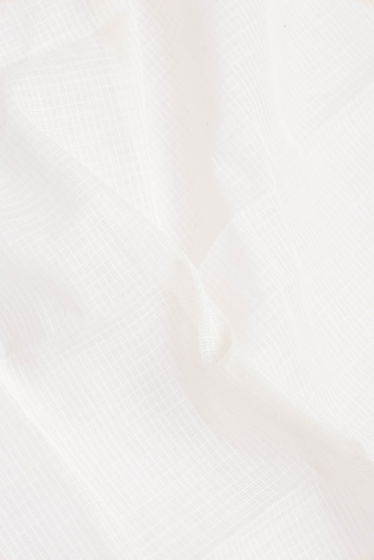 Close up of White Gadwal cotton Saree with Checked design on the body and Zari Border.  displaying folds