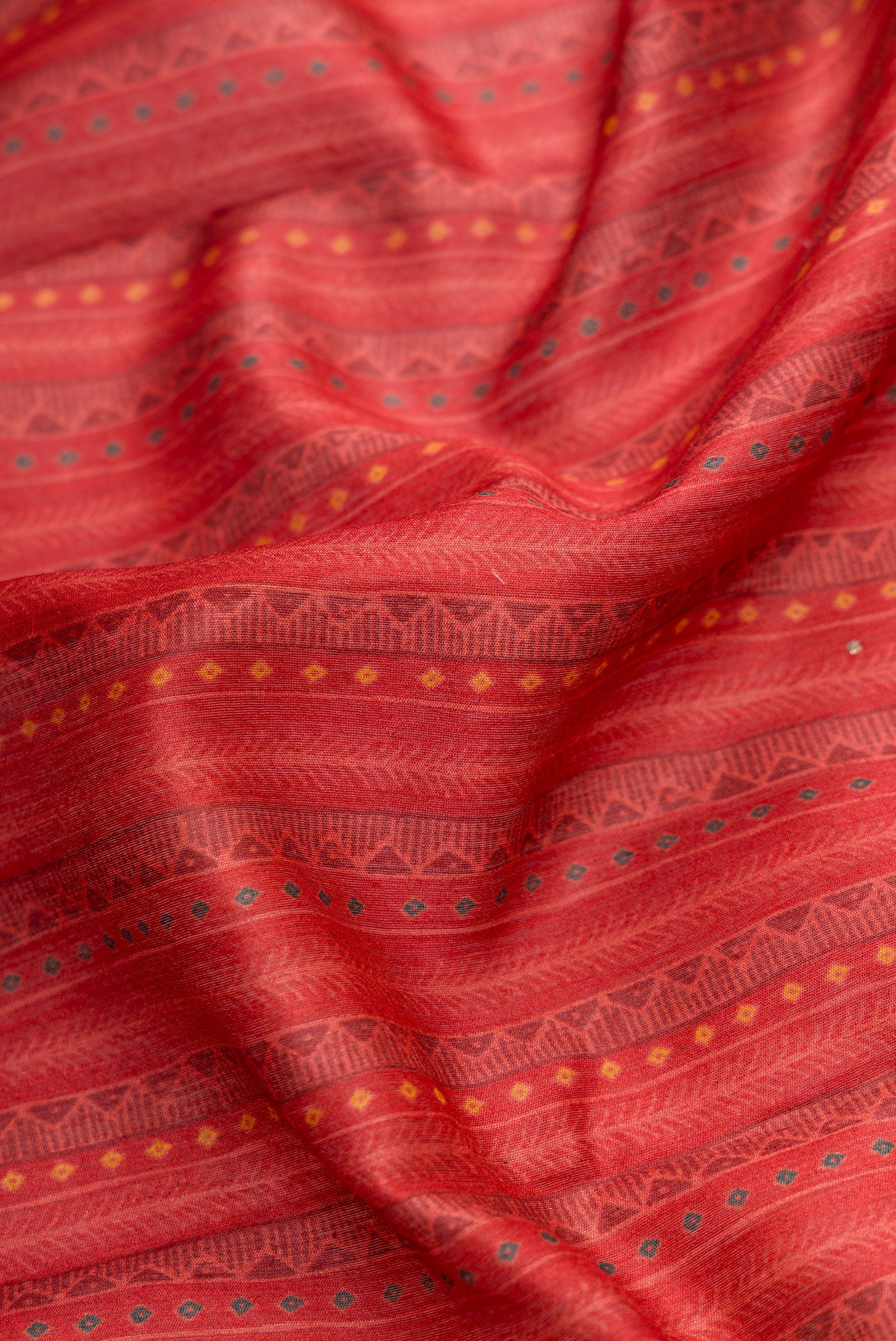 Close up of Dark Pink Dual Tone Tussar Silk Saree with Printed design on the body and Thread Border.  displaying folds