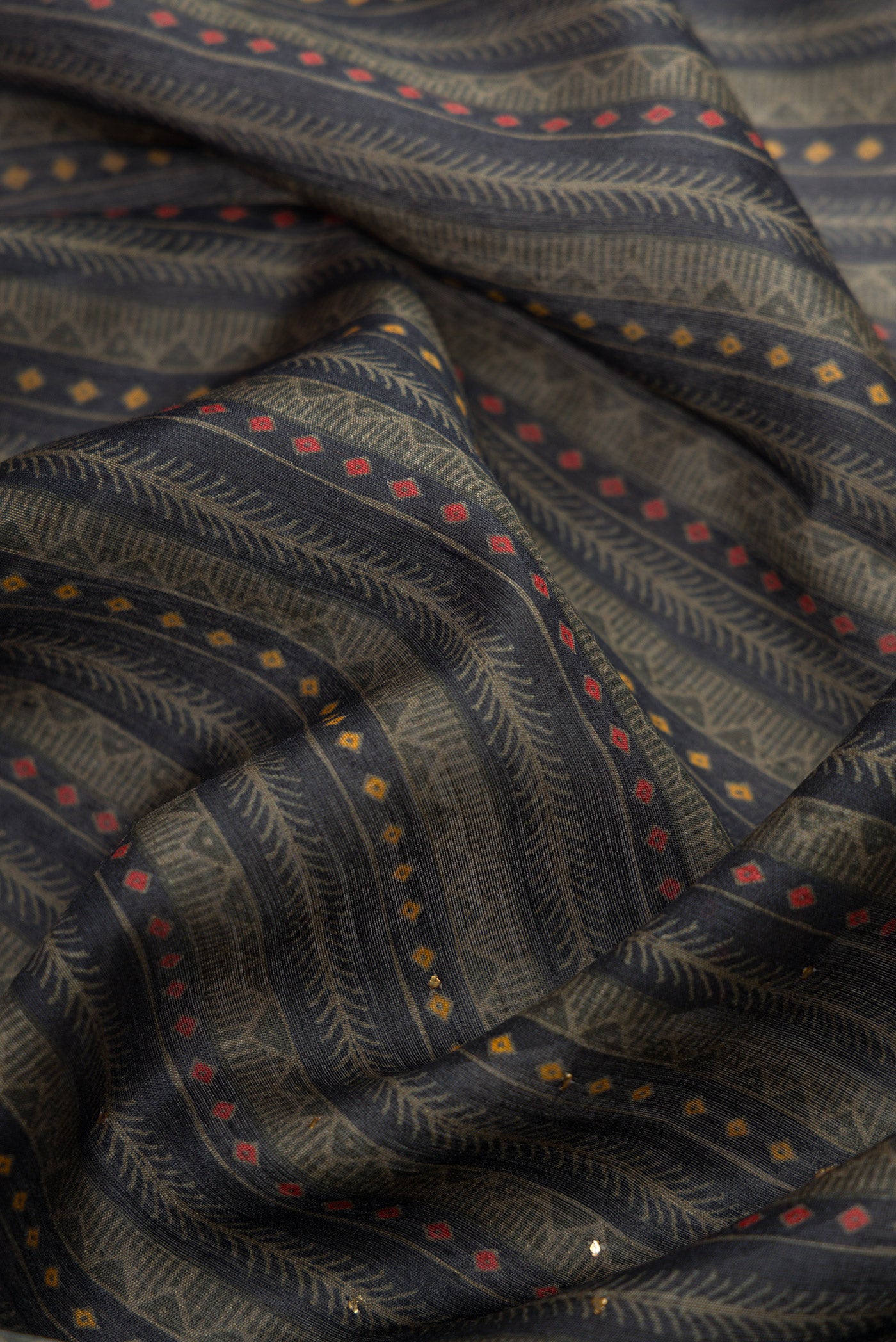 Close up of Navy Blue Dual Tone Tussar Silk Saree with Printed design on the body and Thread Border.  displaying folds