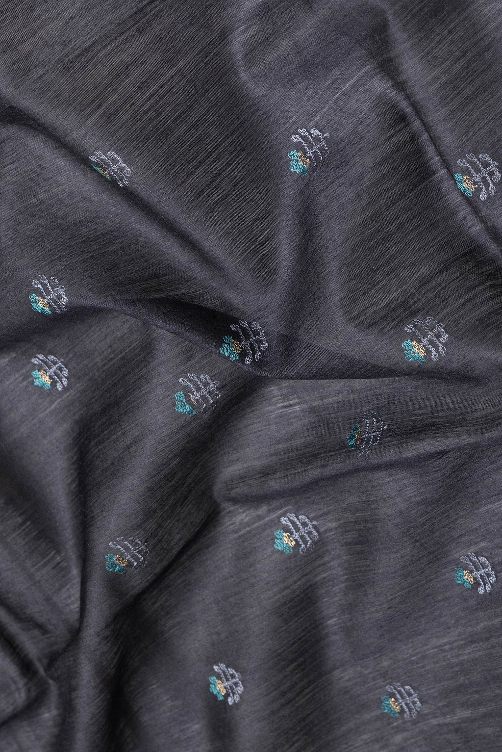 Close up of Black Dual Tone Tussar Silk Saree with Embroidery on the body and Fancy Border.  displaying folds