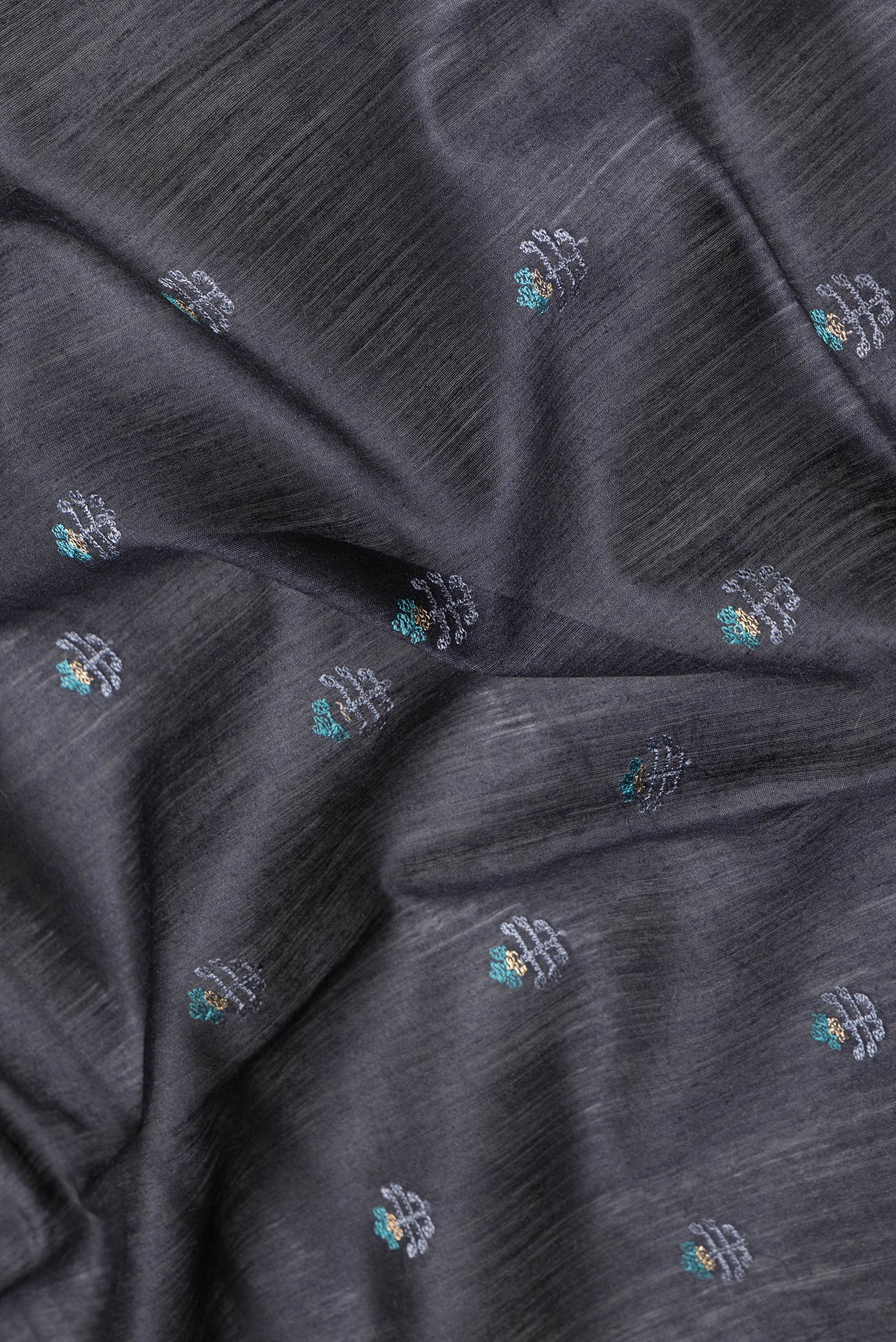 Close up of Black Dual Tone Tussar Silk Saree with Embroidery on the body and Fancy Border.  displaying folds