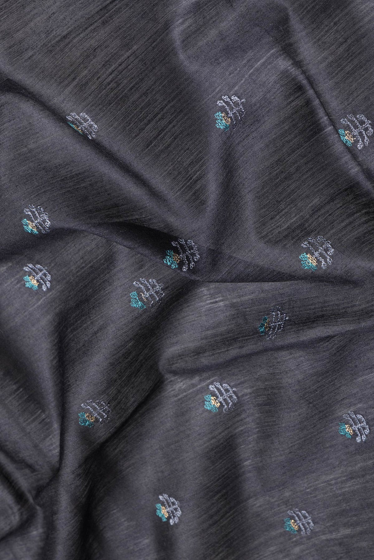 Close up of Black Dual Tone Tussar Silk Saree with Embroidery on the body and Fancy Border.  displaying folds