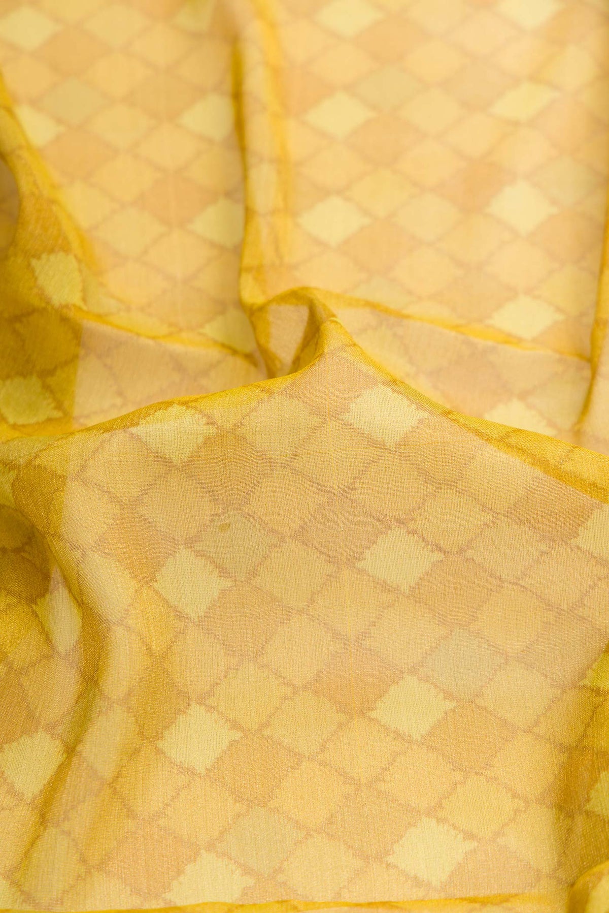 Close up of Mehandi Green Dual Tone Mysore Georgette Saree with Printed design on the body and Fancy Border displaying folds