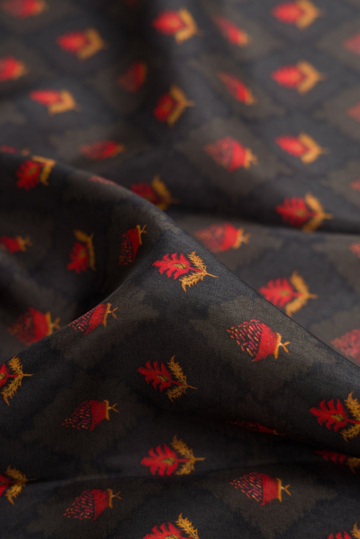 Close up of Black Dual Tone Printed Silk Saree with Printed design on the body and Plain Border.  displaying folds