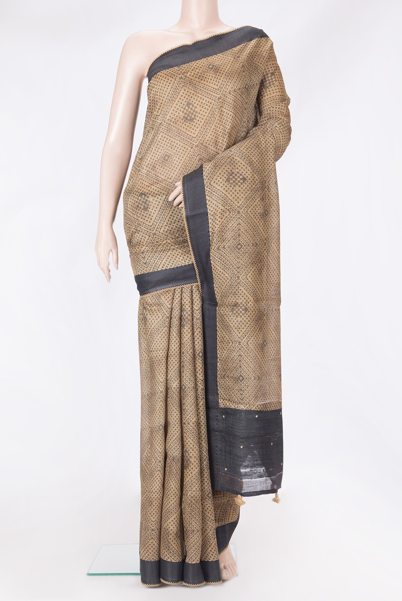 Beige Tussar Silk Saree with Printed design on the body and Embroidery Border.  displayed on a mannequin