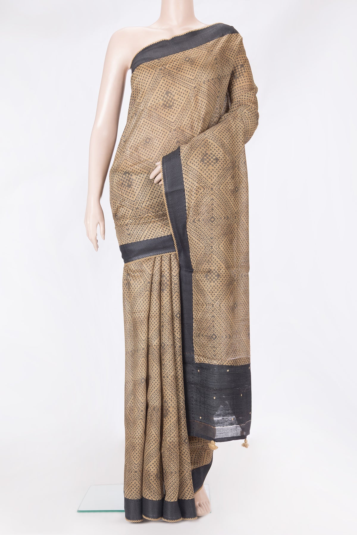 Beige Tussar Silk Saree with Printed design on the body and Embroidery Border.  displayed on a mannequin