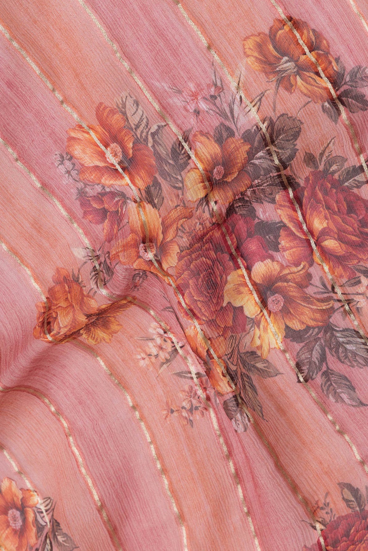 Close up of Golden Peach Dual Tone Mysore Georgette Saree with Stripes on the body and Zari Border.  displaying folds