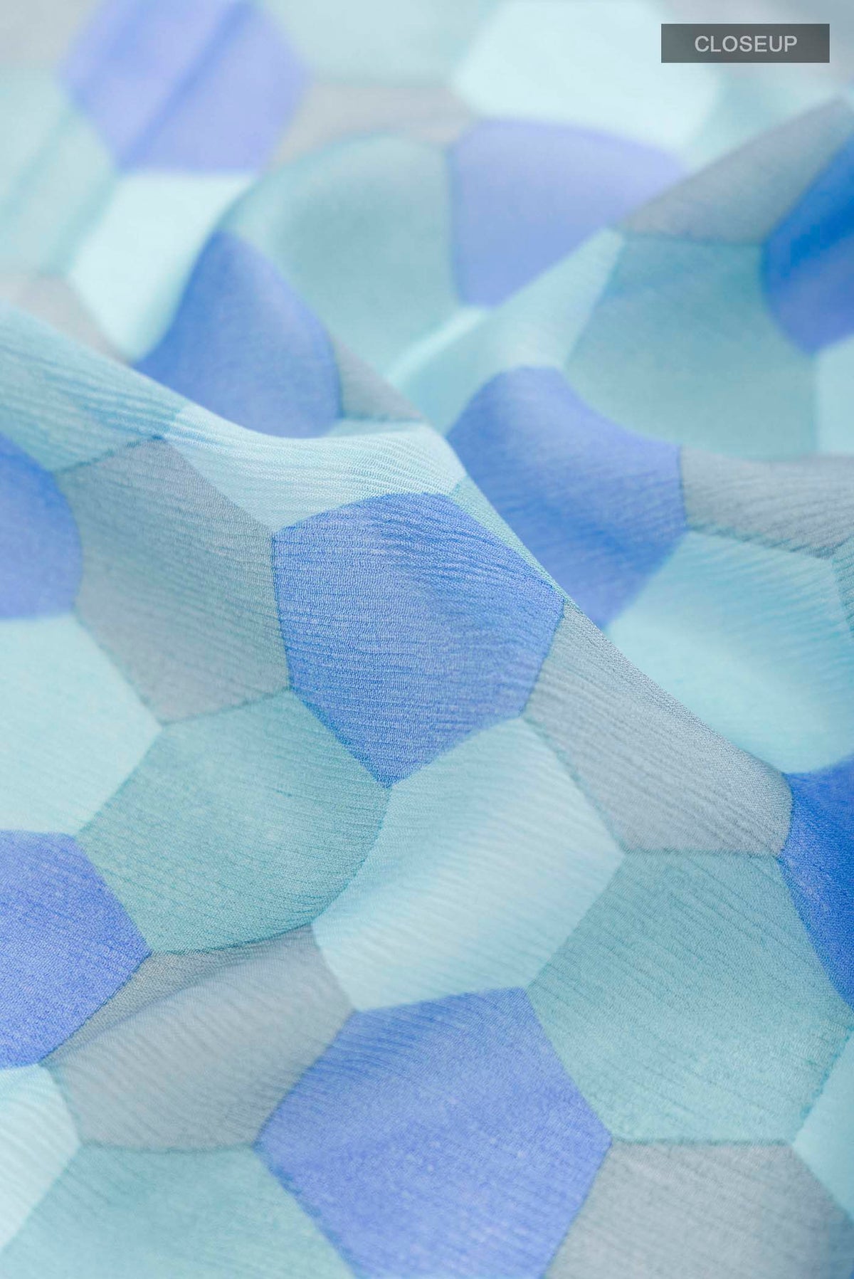 Close up of Blue Mysore Chiffon Saree Printed design on the body and Plain Border displaying folds