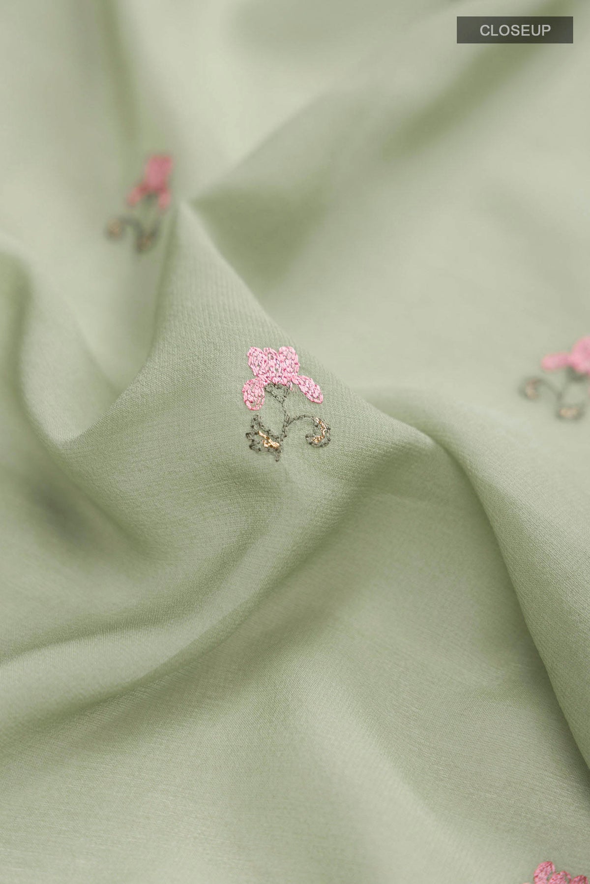 Close up of Green Mysore Georgette Saree with Embroidery on the body and Embroidery Border displaying folds
