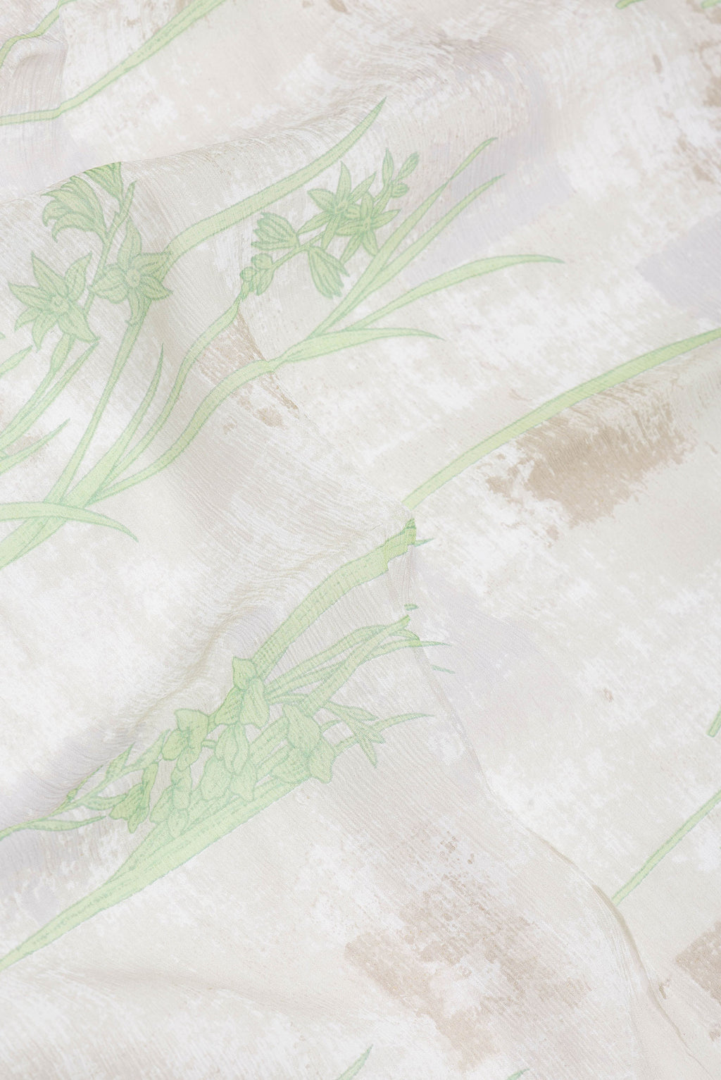 Close up of Beige Dual Tone Mysore Georgette Saree with Printed design on the body and Zari Border.  displaying folds