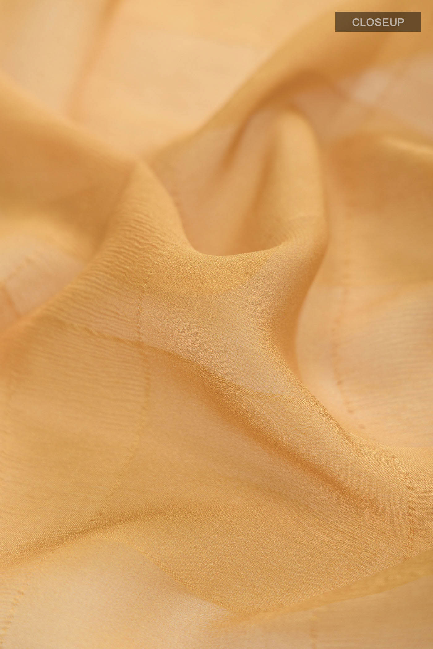 Close up of Yellow Mysore Chiffon Saree Printed design on the body and Zari Border displaying folds