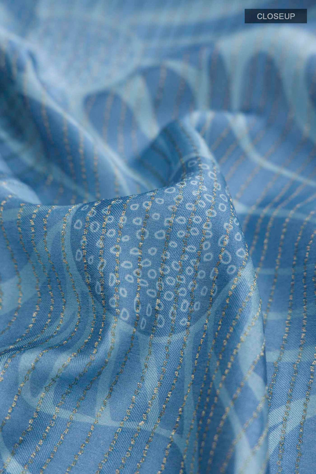 Close up of Blue Crepe Saree Printed design on the body and Zari Border displaying folds