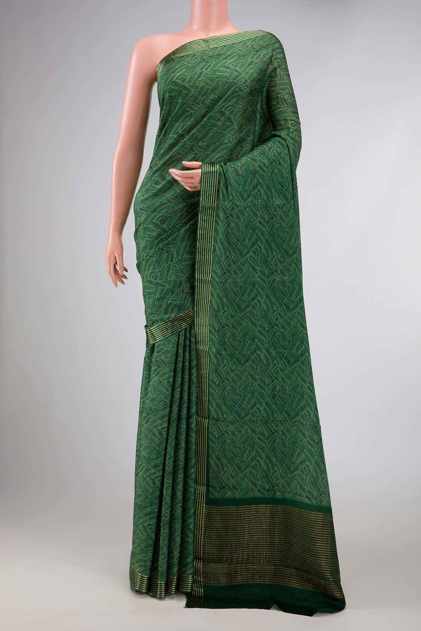 Green Dual Tone Mysore Crepe Saree with Zari Brocade on the body and Zari Border displayed on a mannequin