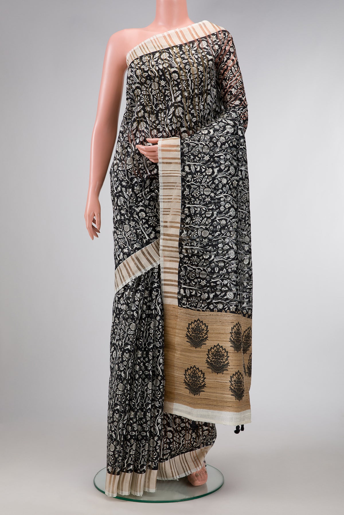 Black Dual Tone Tussar Silk Saree with Printed design on the body and Zari Border.  displayed on a mannequin
