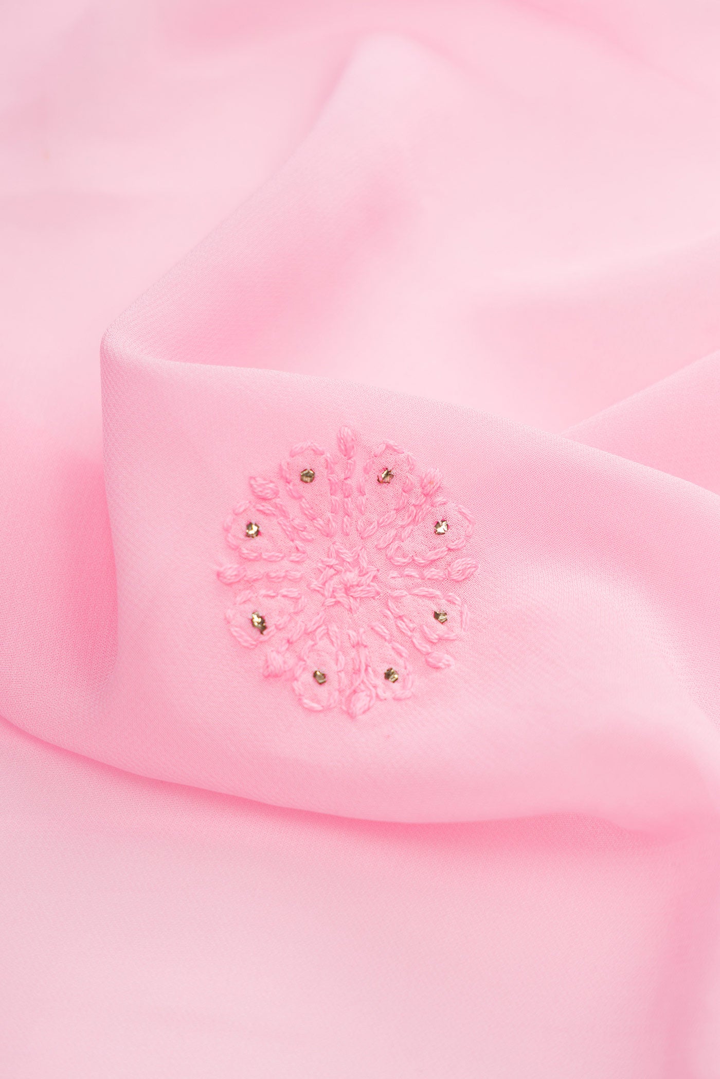 Close up of Rose pink Dual Tone Georgette Saree with Embroidery on the body and Embroidery Border.  displaying folds