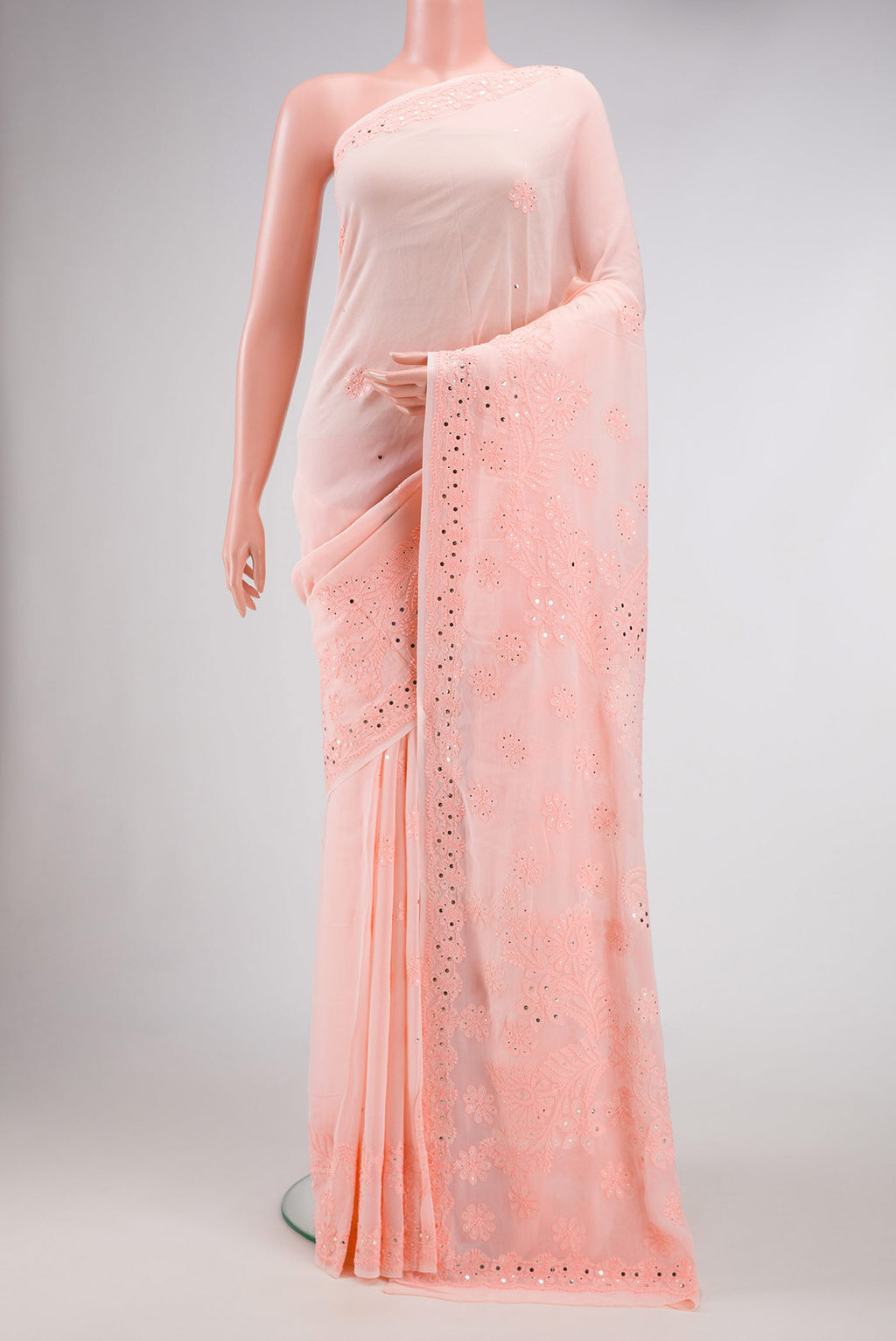 Peach Dual Tone Georgette Saree with Embroidery on the body and Embroidery Border.  displayed on a mannequin