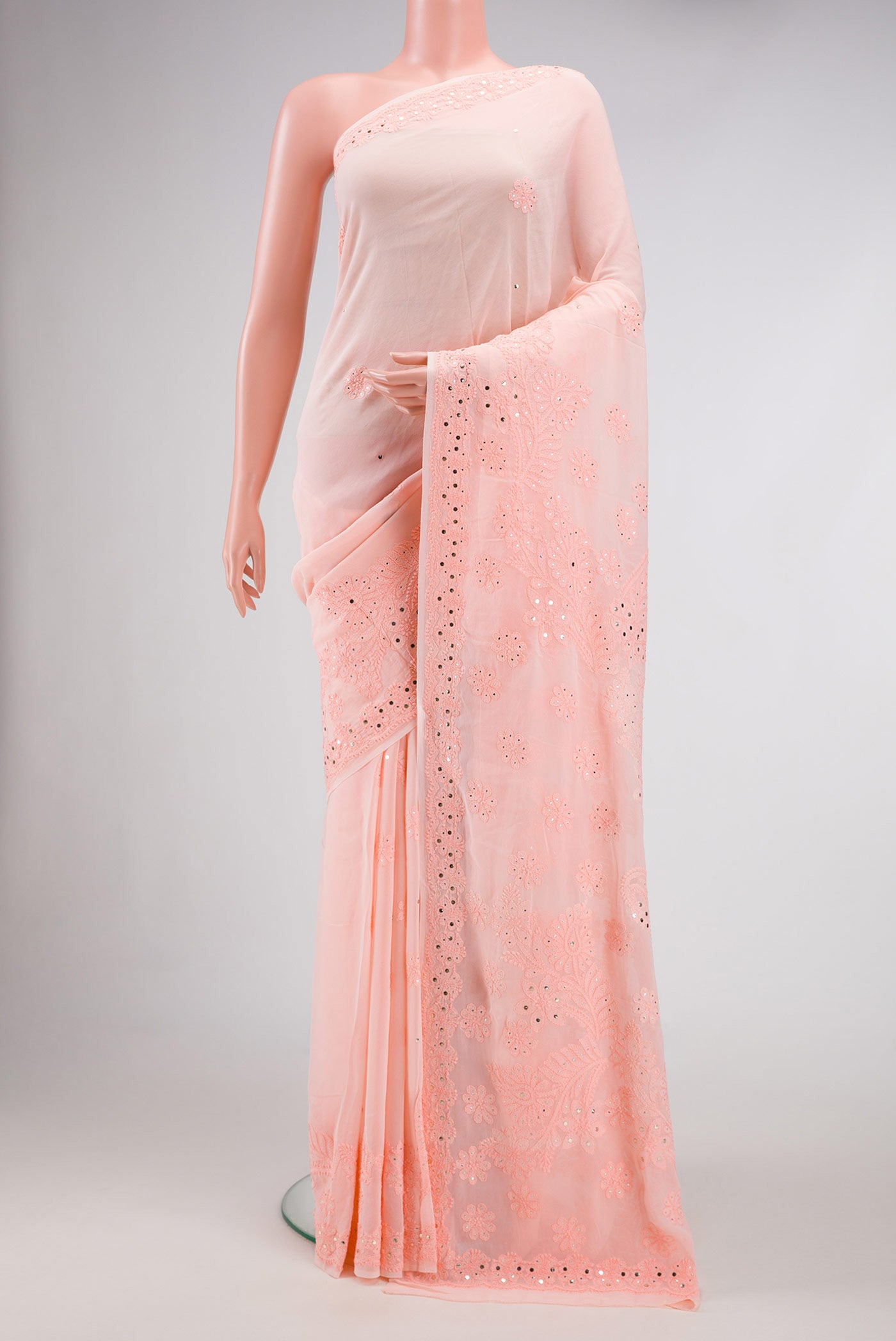 Peach Dual Tone Georgette Saree with Embroidery on the body and Embroidery Border.  displayed on a mannequin