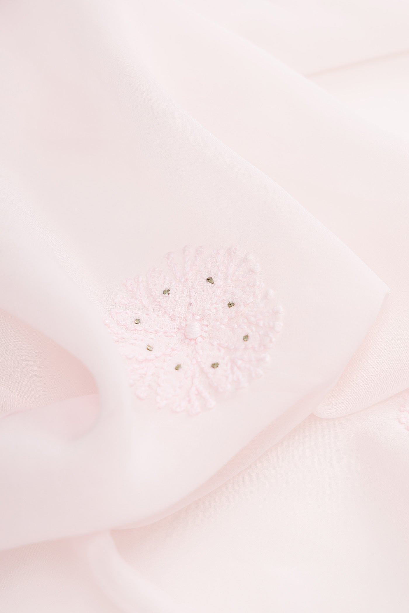 Close up of Rose pink Dual Tone Georgette Saree with Embroidery on the body and Embroidery Border.  displaying folds