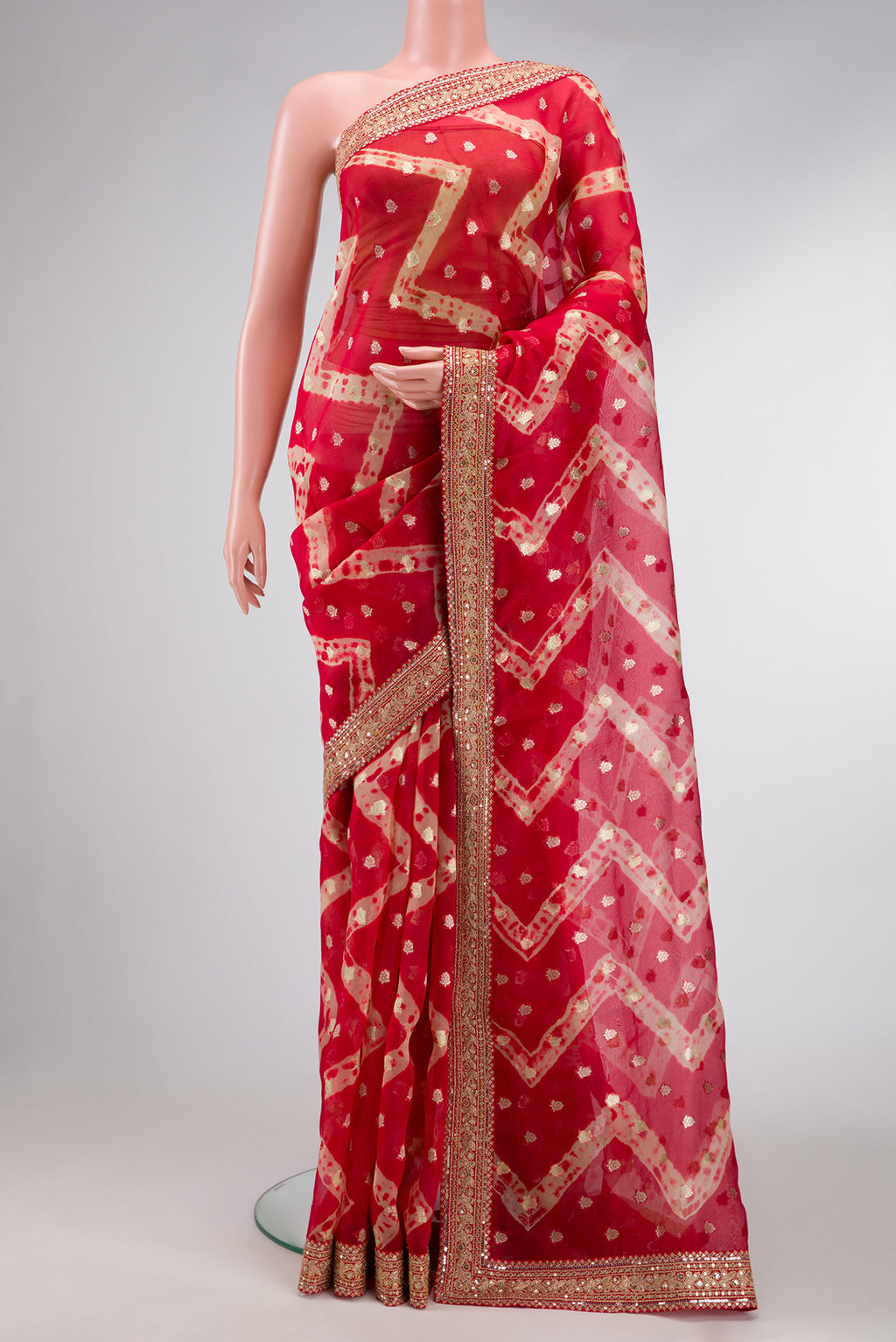 Red Dual Tone Organza Silk Saree with Zari Butta on the body and Embroidery Border.  displayed on a mannequin