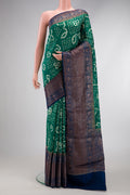 Green Dual Tone Bandhani Silk Saree with Bandhani Print on the body and Zari Border.  displayed on a mannequin