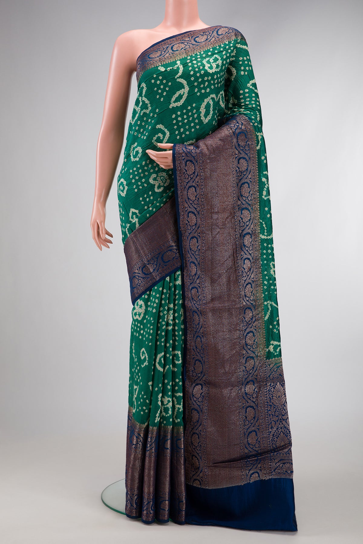 Green Dual Tone Bandhani Silk Saree with Bandhani Print on the body and Zari Border.  displayed on a mannequin