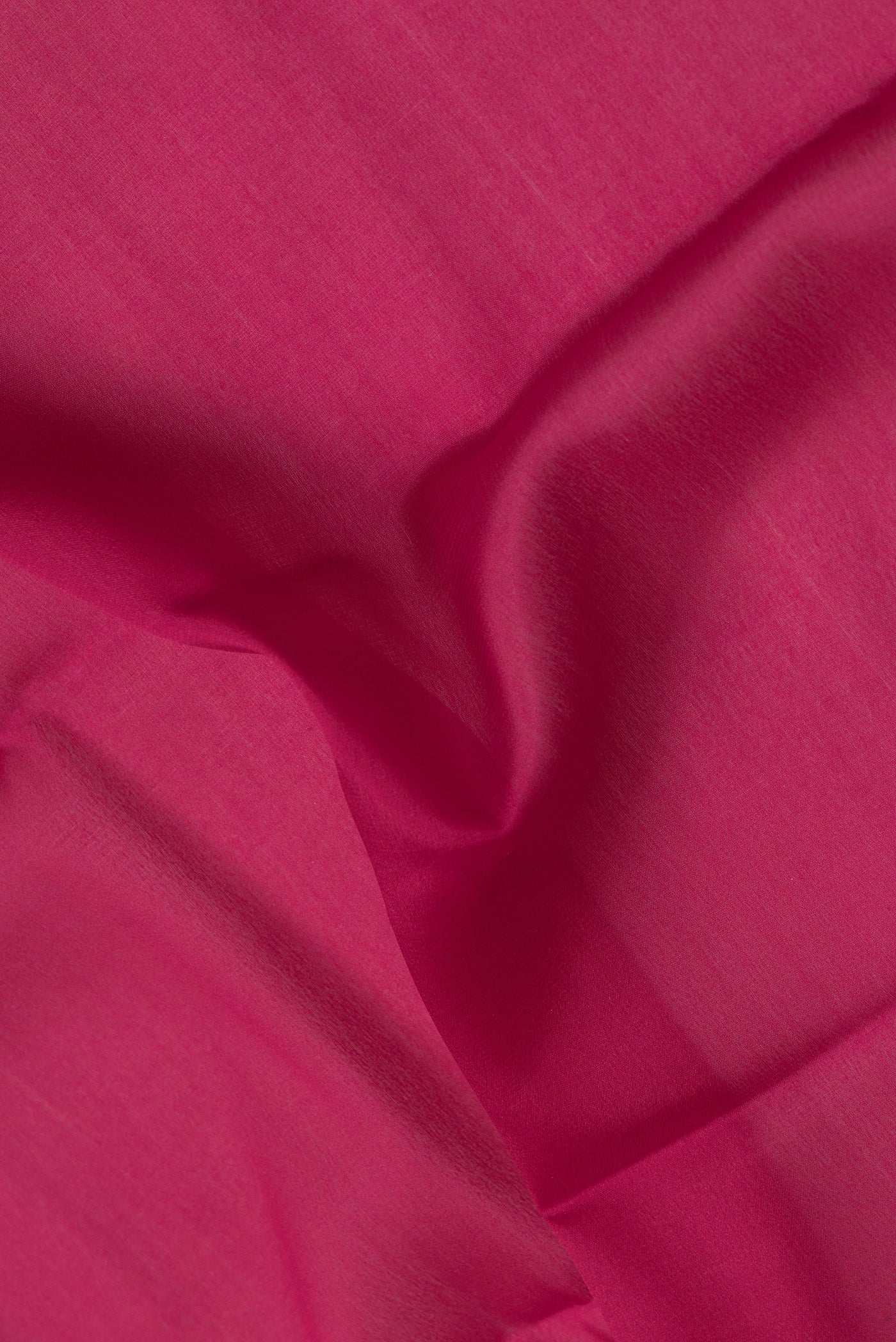 Close up of Pink Mysore Crepe Saree with Plain Body and Zari Border.  displaying folds