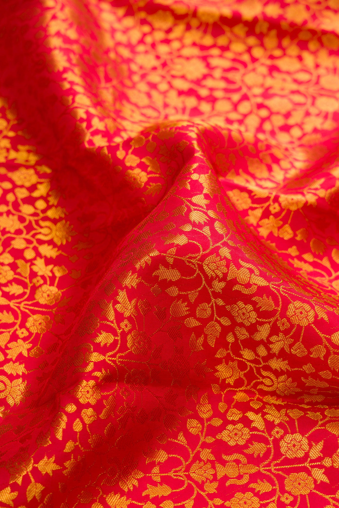 Close up of Dark Pink Dual Tone Kanchipuram Silk Saree with Zari Brocade on the body and Zari Border.  displaying folds