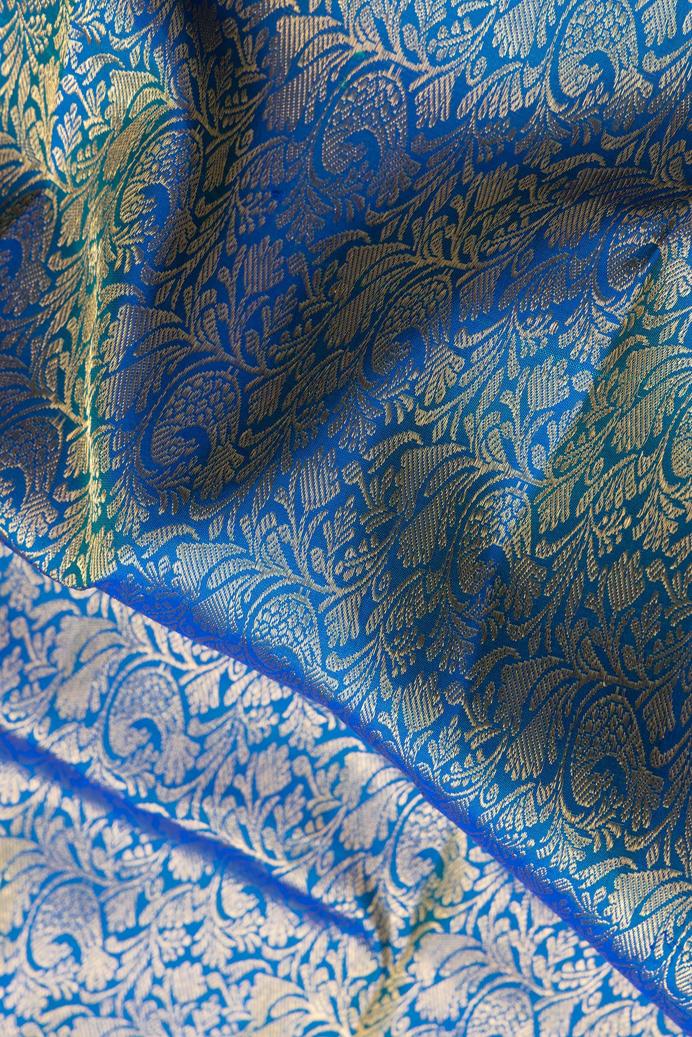 Close up of Royal Blue Dual Tone Kanchipuram Silk Saree with Zari Brocade on the body and Zari Border.  displaying folds