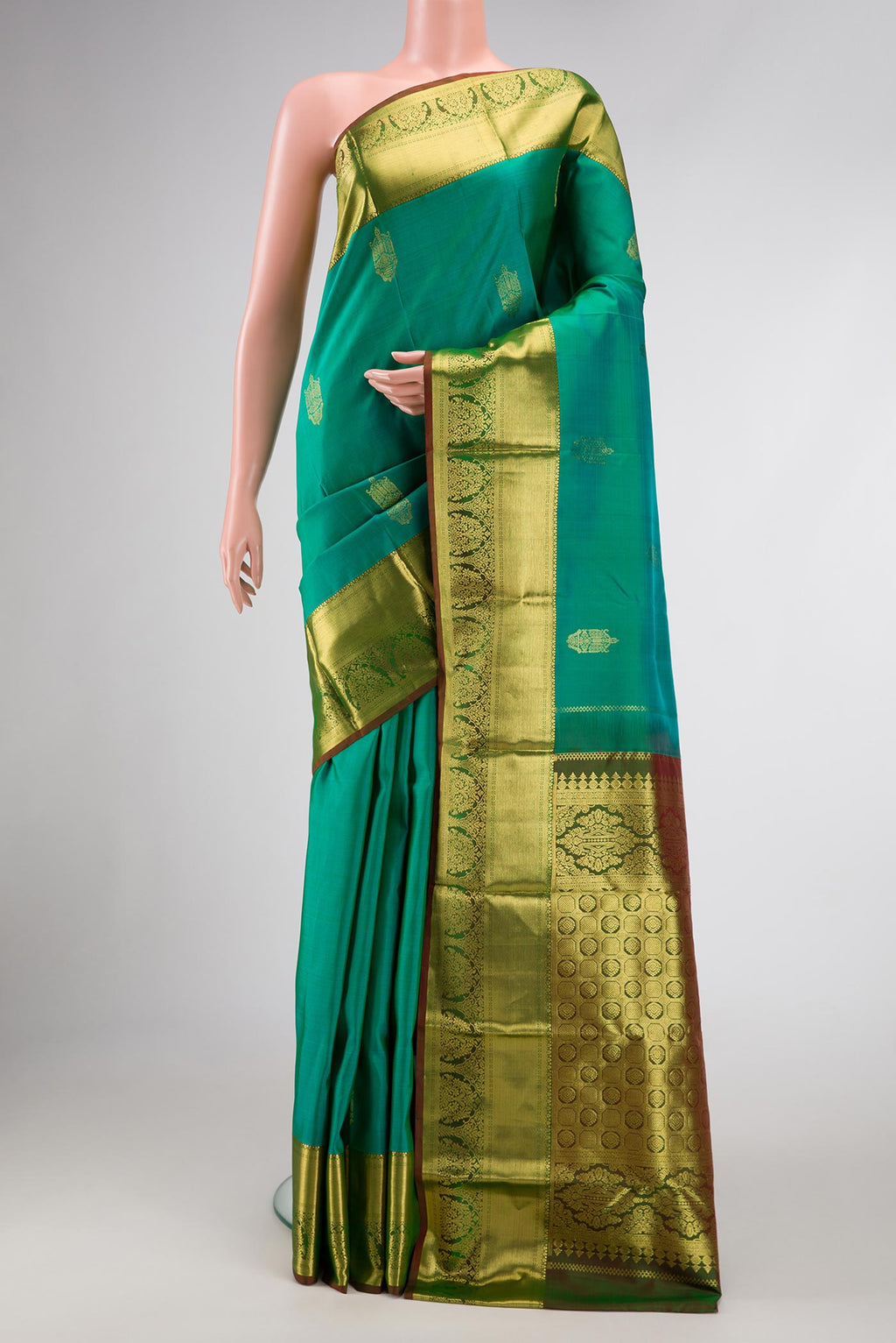 Sea Green Dual Tone Kanchipuram Silk Saree with Zari Butta on the body and Zari Border.  displayed on a mannequin