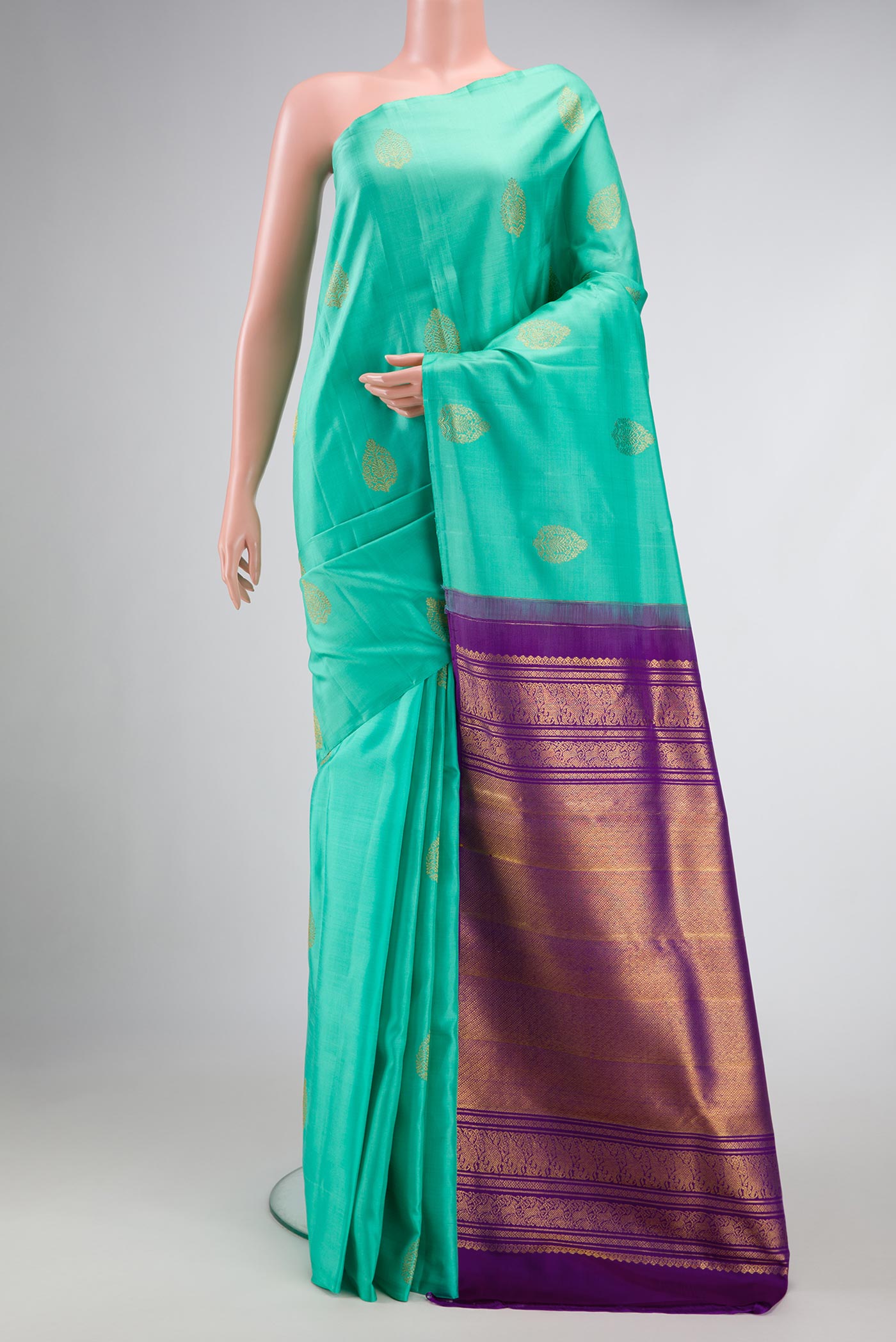 Sea Green Dual Tone Kanchipuram Silk Saree with Zari Butta on the body and Without Border.  displayed on a mannequin