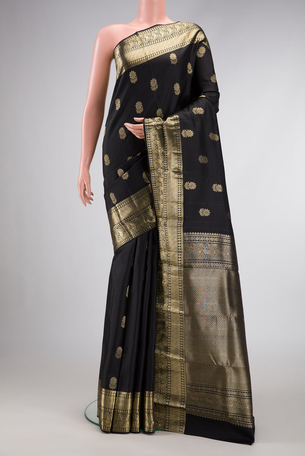 Black Dual Tone Kanjivaram Silk Saree with Zari Butta on the body and Zari Border.  displayed on a mannequin