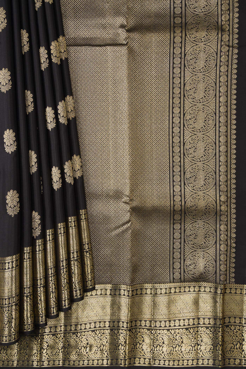 Pleats and pallu of Black Dual Tone Kanjivaram Silk Saree with Zari Butta on the body and Zari Border. 