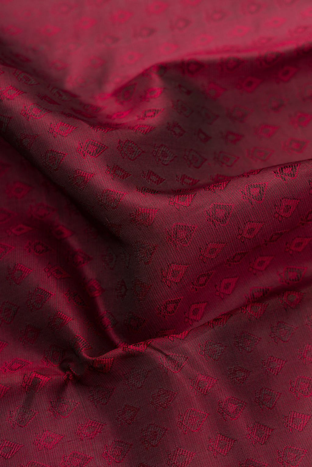 Close up of Maroon Dual Tone Kanchipuram Silk Saree with Jacquard design on the body and Fancy Border.  displaying folds
