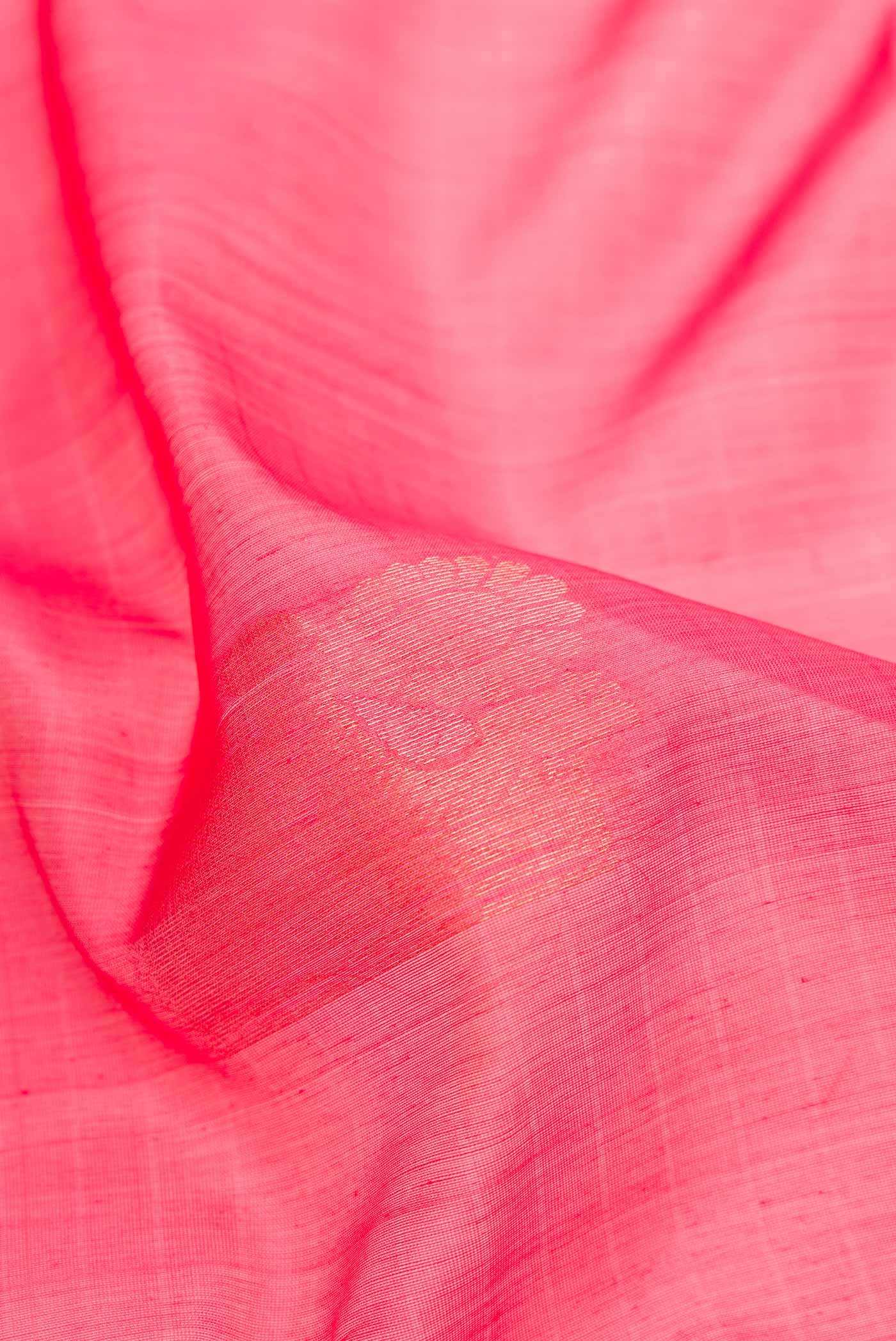 Close up of Pink Dual Tone Silk Cotton Saree with Zari Butta on the body and Zari Border.  displaying folds