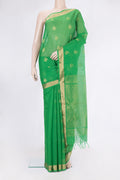 Green Silk Cotton Saree with Zari Butta on the body and Zari Border.  displayed on a mannequin